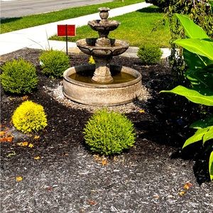 My beautiful landscape w. 3 tire fountain and canna lilies weeping cherry tree